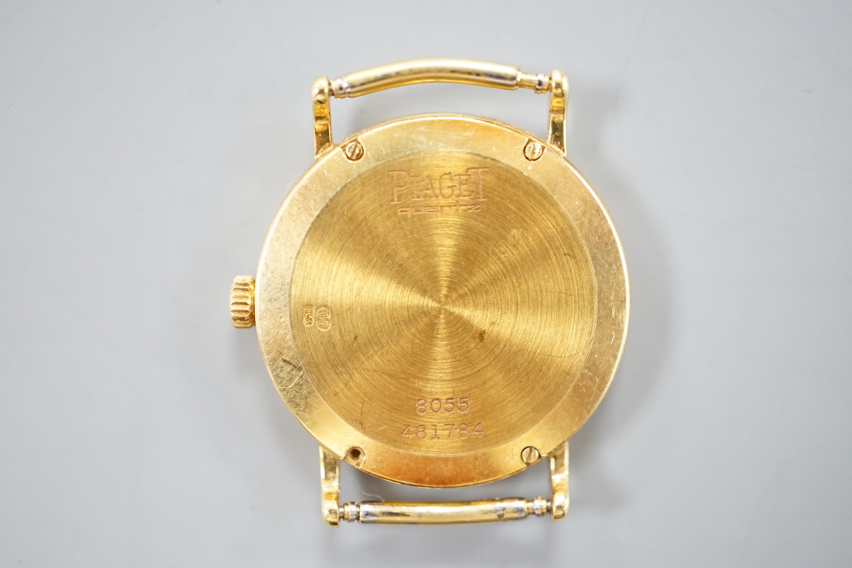 A lady's modern 18ct gold Piaget quartz wrist watch, with Roman dial, no strap, case diameter 23mm, gross weight 12.1 grams.